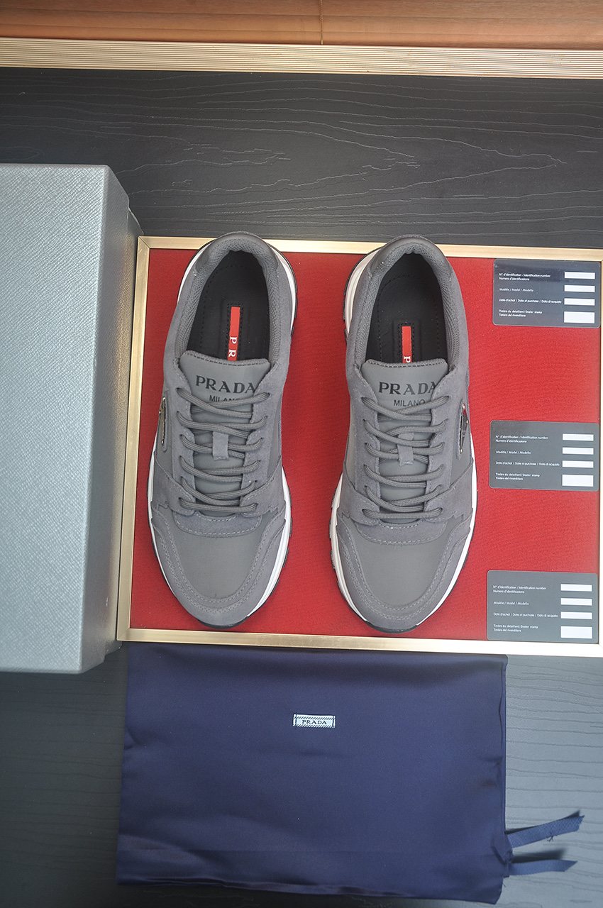 Prada Triangle Plaque Low-Top Sneakers — front